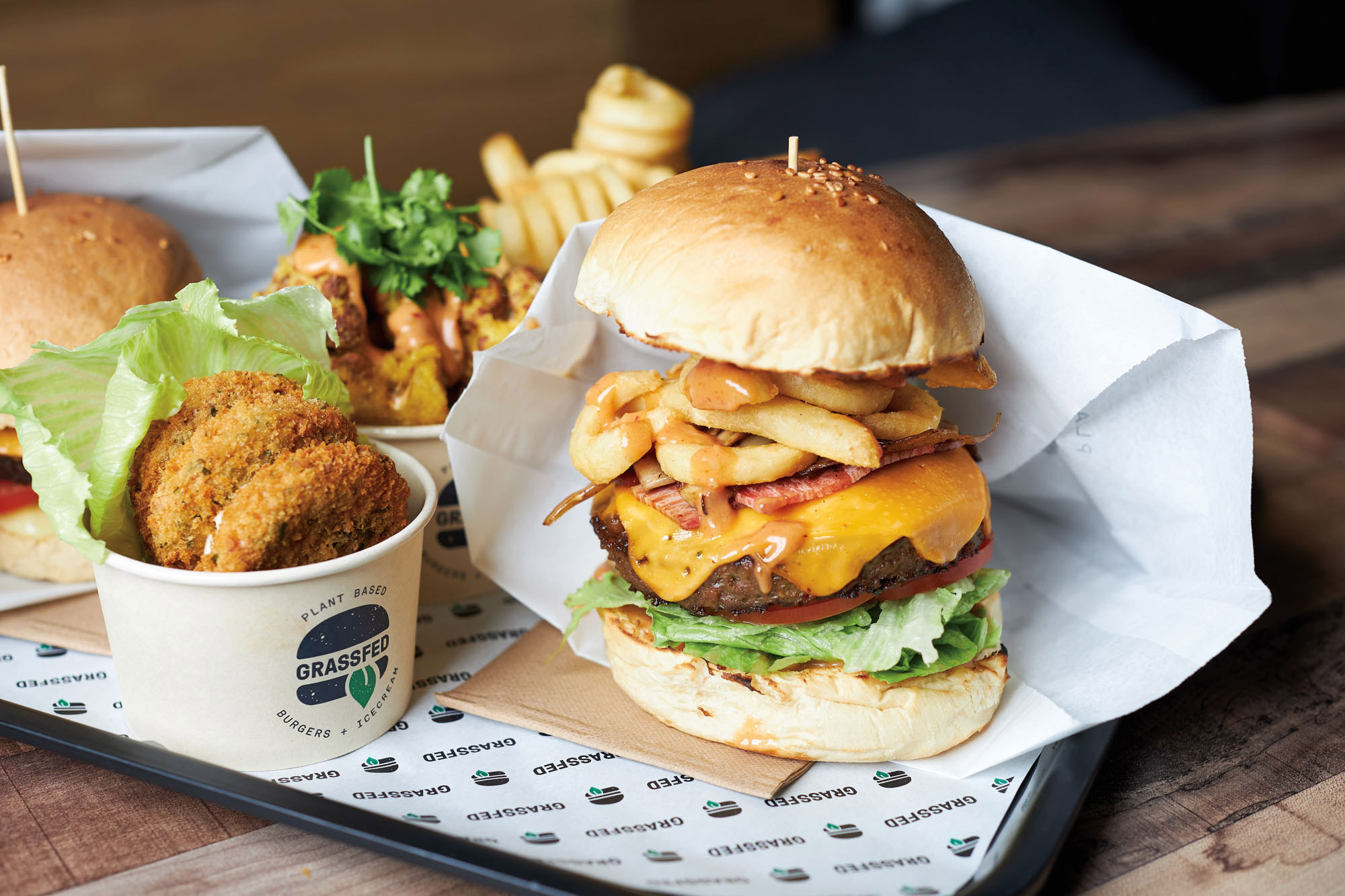 Grassfed vegan restaurant brand with juicy burger and onion rings